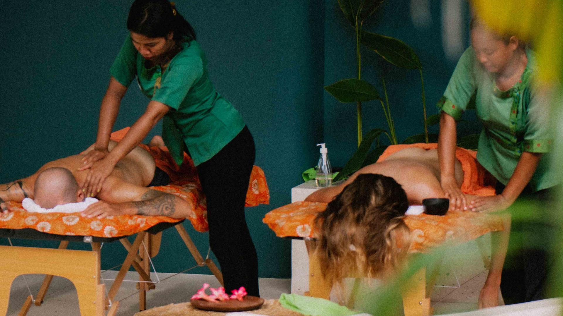 A couple enjoying a massage in their private villas